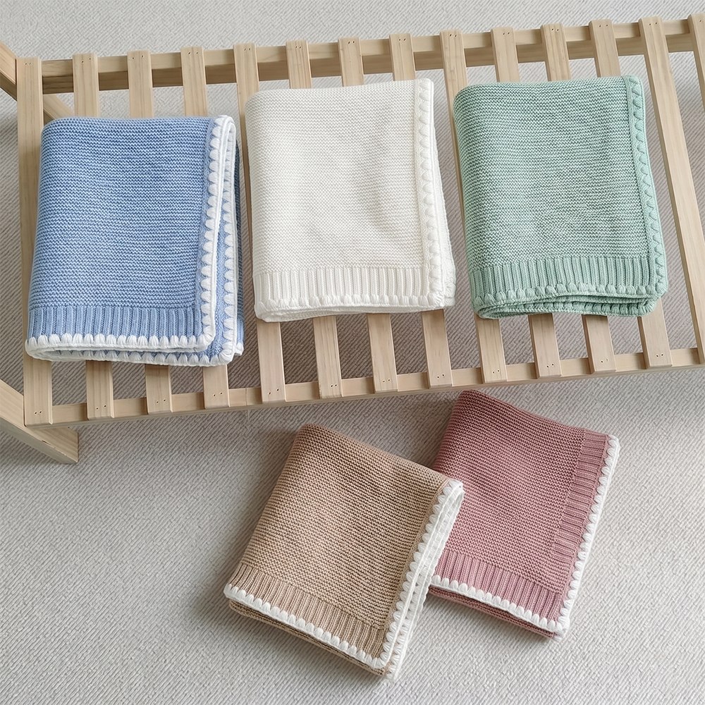 Bespoke contrast edge knit infant throw designed for premium private label brands
