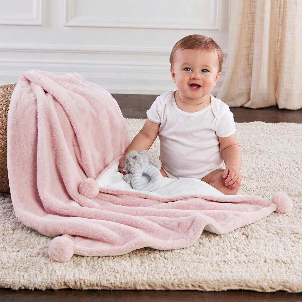 Double-layer flannel baby blanket with pom-poms for bulk OEM orders by baby textile manufacturer